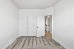 Unfurnished bedroom featuring carpet floors and a closet