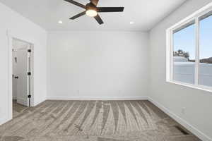 Empty room with light carpet, ceiling fan, and recessed lighting
