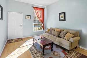 Living room featuring baseboards and light wood-style flooring