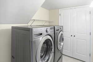 Washroom featuring washing machine and clothes dryer