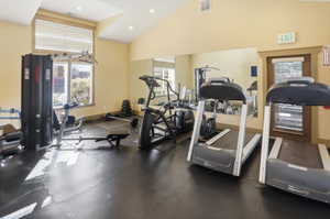 Club house gym with recessed lighting and high vaulted ceiling