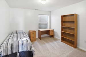 Bedroom featuring light colored carpet and baseboards