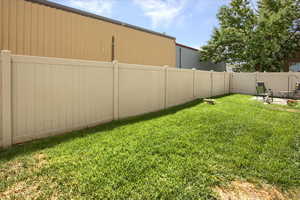 Fenced backyard featuring a patio