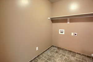 Laundry room with hookup for a washing machine and hookup for an electric dryer