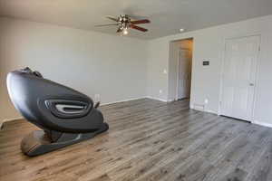 Living room with light wood-style flooring and ceiling fan
