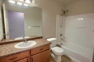 Full bath with tub / shower combination, vanity, and light tile patterned floors