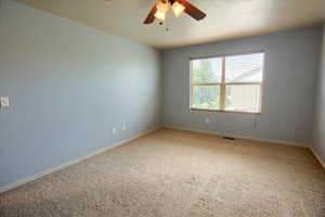 Owner's Suite bedroom with carpet and ceiling fan