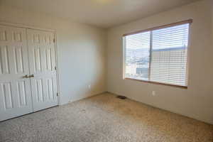 Bedroom featuring carpet floors and a closet