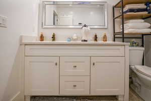 Bathroom with double vanity and toilet