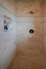 Full bath featuring tiled shower