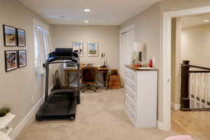 Workout area featuring light colored carpet and recessed lighting