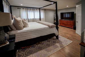 Bedroom featuring wood finished floors and recessed lighting