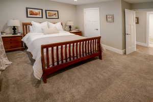 Bedroom with light carpet and baseboards