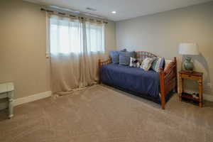 Carpeted bedroom featuring baseboards