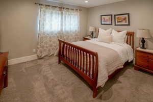 Bedroom featuring carpet flooring and baseboards