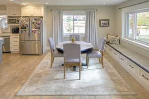 Dining area with light wood-style flooring and recessed lighting