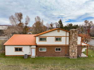 View of front of home with a metal roof and a standing seam roof