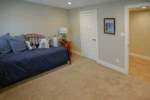 Carpeted bedroom featuring baseboards and recessed lighting