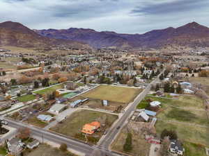 Aerial overview of property's location featuring a mountainous background and nearby suburban area