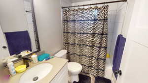 Bathroom featuring vanity and shower / bathtub combination with curtain