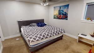 Bedroom with light carpet and ceiling fan