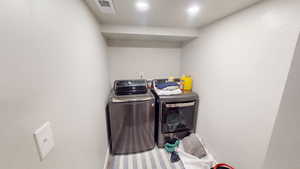 Laundry room with separate washer and dryer and baseboards