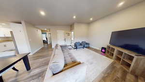 Living area featuring recessed lighting and light wood finished floors