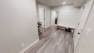 Hallway featuring light wood-type flooring and recessed lighting