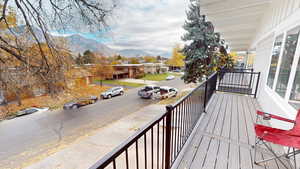 Wooden deck featuring a mountain view and a residential view