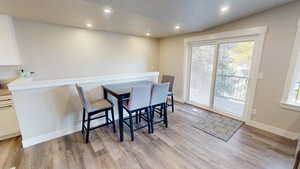 Dining space with recessed lighting, healthy amount of natural light, and light wood-type flooring