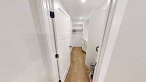 Walk in closet featuring light colored carpet