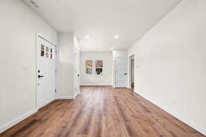 Foyer entrance featuring wood finished floors and recessed lighting