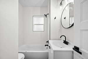 Bathroom with vanity and shower / tub combination