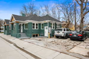 View of front of house with roof with shingles and a chimney