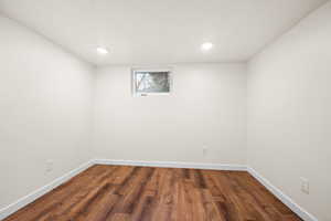 Unfurnished room featuring dark wood finished floors and recessed lighting