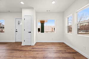 Spare room with recessed lighting, wood finished floors, and a textured ceiling