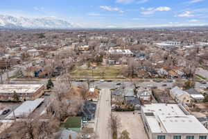 Aerial view of property and surrounding area featuring nearby suburban area