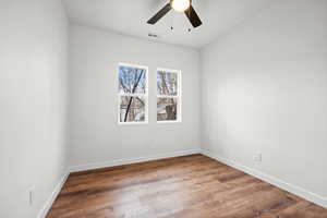Empty room with wood finished floors and ceiling fan