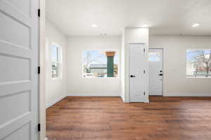 Foyer featuring dark wood-style floors, recessed lighting, and a textured ceiling
