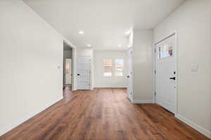 Foyer entrance featuring dark wood-style flooring and recessed lighting