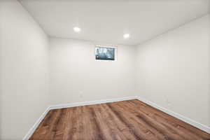 Spare room with wood finished floors and recessed lighting