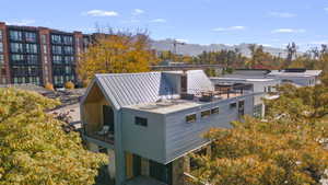 Exterior space featuring a metal roof, a mountain view, and a balcony