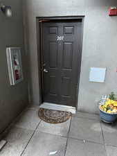 Entrance to property featuring stucco siding