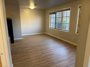 Living room with light wood-type flooring and baseboards