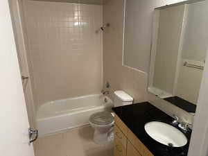 Full bath with light tile patterned flooring, vanity, tile walls, and bathing tub / shower combination