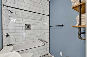 Bathroom featuring toilet and tiled shower / bath