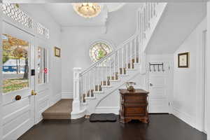 Foyer entrance with stairs and dark wood finished floors