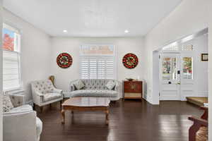 Living area featuring dark wood-type flooring, recessed lighting, and a textured ceiling
