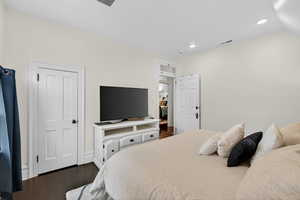 Bedroom with dark wood-style floors and recessed lighting