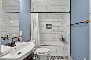 Full bathroom featuring vanity, tiled shower / bath, tile walls, and tile patterned floors